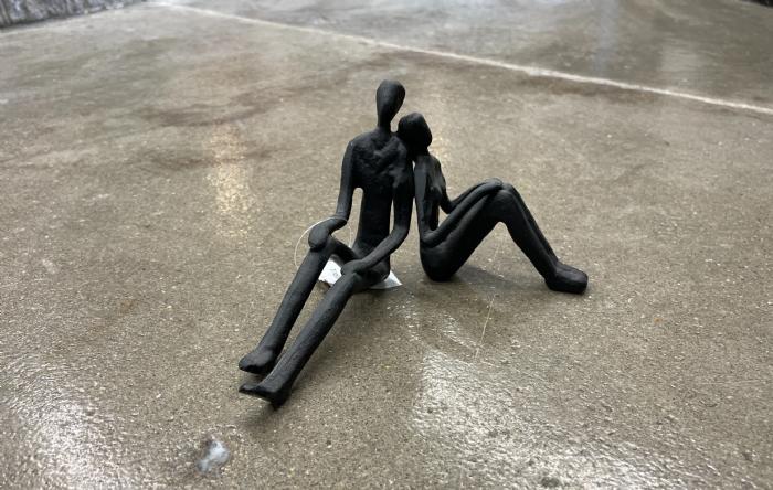 salg af Par siddende sort metal